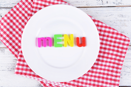 Inscription menu on plate on table close-upの写真素材