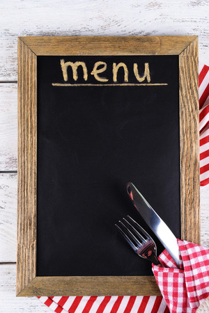Inscription menu on chalkboard on table close-upの写真素材