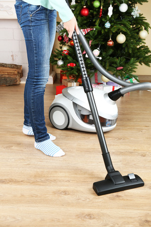 Woman with vacuum cleaner in roomの写真素材