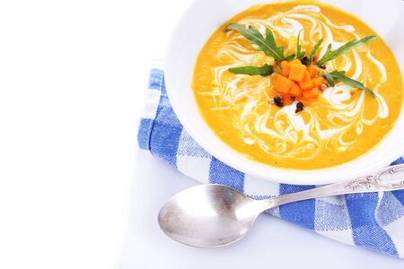 Pumpkin soup and pumpkin slices on napkin, isolated on whiteの写真素材