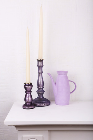 White candles in candle holders on white backgroundの写真素材