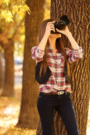 Beautiful young photography take photos outdoors in parkの写真素材