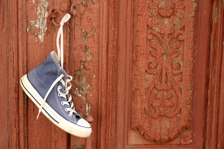 Sneaker hanging on wooden doorの写真素材