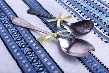 Spoons on fabric background