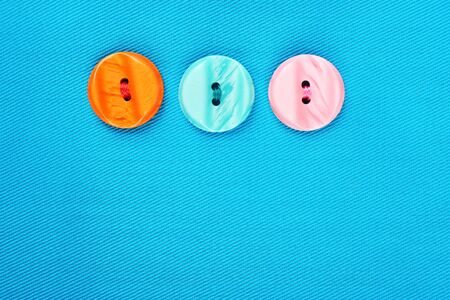 Buttons on blue cloth, close up