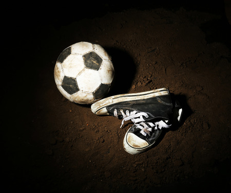 Soccer ball on ground on dark background