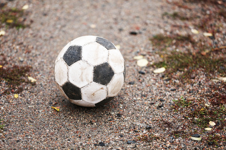 Soccer ball on ground in rainy day, outdoorsの写真素材