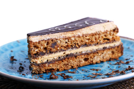 Delicious chocolate cake on plate on table close-up