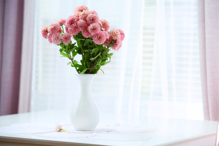 Beautiful flowers in vase with light from windowの写真素材