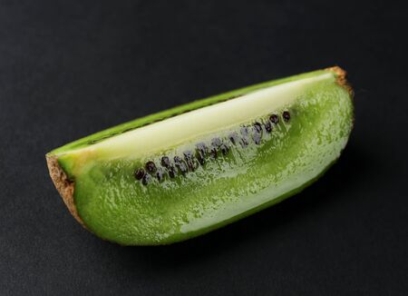 Kiwi slice on black backgroundの写真素材
