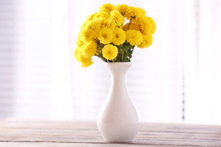 Beautiful flowers in vase with light from windowの写真素材