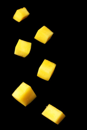 Mango slices on black backgroundの写真素材