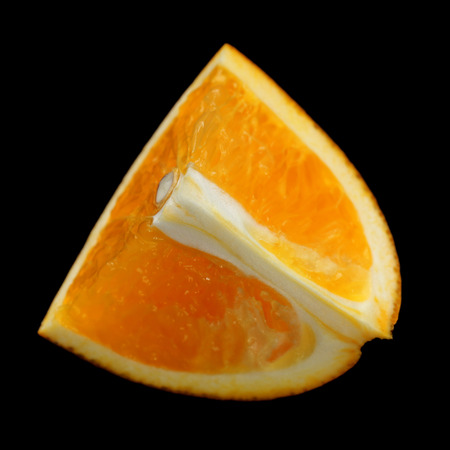 Orange slice on black backgroundの写真素材