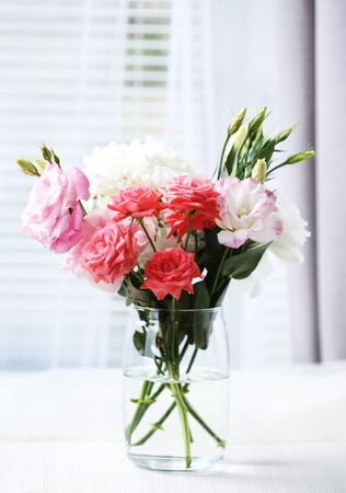 Beautiful flowers in vase with light from windowの写真素材