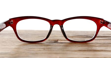 Eye glasses on wooden table on white backgroundの写真素材