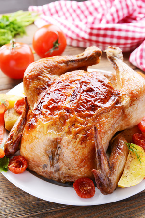 Delicious baked chicken on plate on table close-upの写真素材