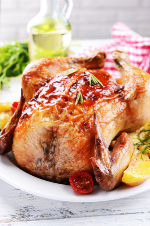 Delicious baked chicken on plate on table close-upの写真素材