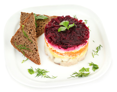 Russian herring salad on plate isolated on whiteの写真素材