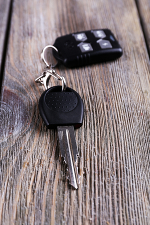 Car key with remote control on wooden table, close-upの写真素材