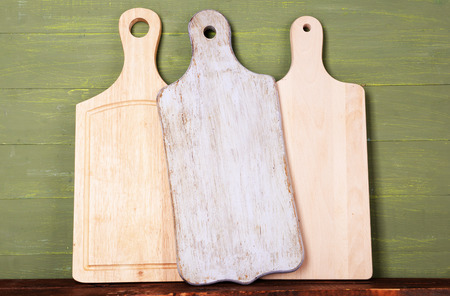 Empty cutting boards on wooden background