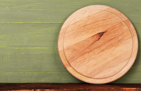 Empty cutting board on wooden backgroundの写真素材