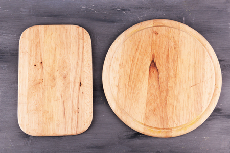 Empty cutting boards on wooden backgroundの写真素材