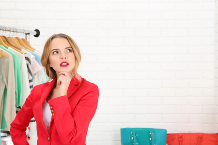 Young girl in shop buying clothesの写真素材