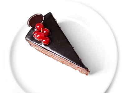 Delicious chocolate cake on plate on table on light backgroundの写真素材