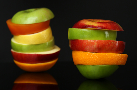 Fresh sliced fruit isolated on blackの写真素材
