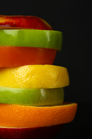 Fresh sliced fruit isolated on blackの写真素材