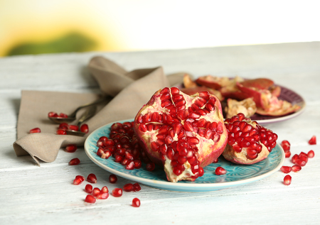 Beautiful composition with juicy  pomegranate seeds, on old wooden tableの写真素材