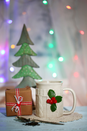 Christmas composition with cup of hot drink, on wooden tableの写真素材