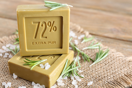 Rosemary handmade soap with the branches of rosemary on sackcloth, on wooden backgroundの写真素材