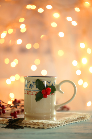 Christmas composition with cup of hot drink, on wooden tableの写真素材