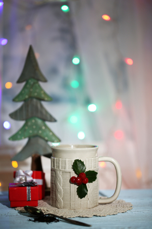 Christmas composition with cup of hot drink, on wooden tableの写真素材