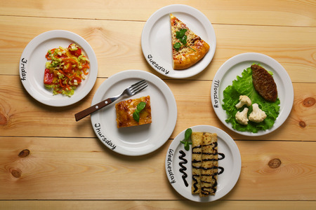 Daily menu. Plates with food on tableの写真素材