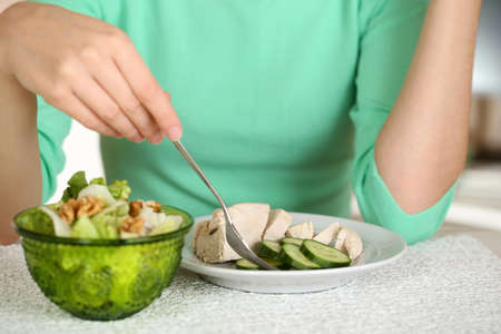 Girl and dietary food at table close-upの写真素材