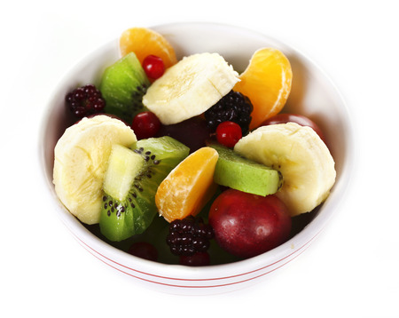 Mix of fruits in bowl isolated on whiteの写真素材