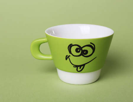 Emotional cup on green backgroundの写真素材
