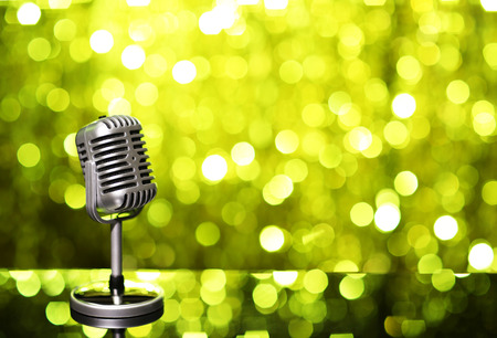 Silver microphone on yellow backgroundの写真素材