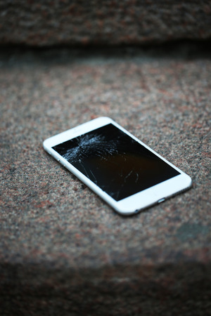 Broken Phone on asphalt outdoorsの写真素材