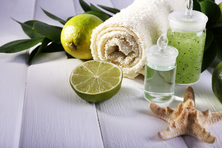 Spa composition with lime and towel color wooden backgroundの写真素材