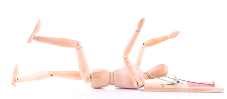 Mousetrap captured wooden mannequin, isolated on white backgroundの写真素材