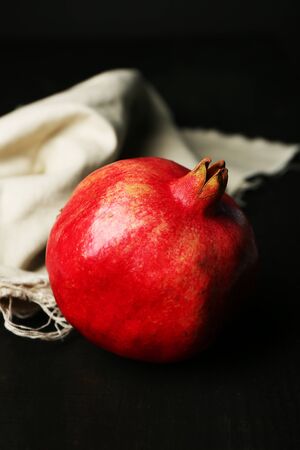 Juicy ripe pomegranates on tableclothの写真素材