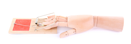 Hand of wooden doll in mousetrap, isolated on white backgroundの写真素材