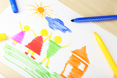 Drawing made by child with colorful pencils on wooden table backgroundの写真素材
