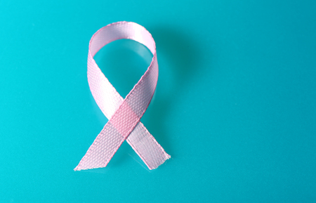 Pink breast cancer ribbon on blue backgroundの写真素材