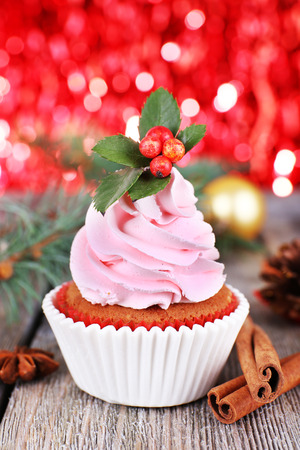 Cup-cake with cream and Christmas decoration on wooden table and shine brightly backgroundの写真素材