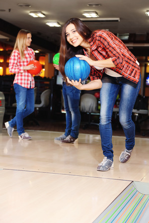 Friends playing in bowling clubの写真素材
