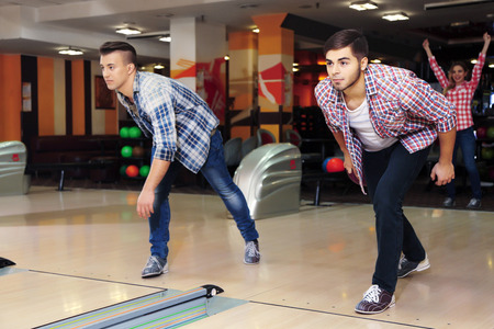 Friends playing in bowling clubの写真素材
